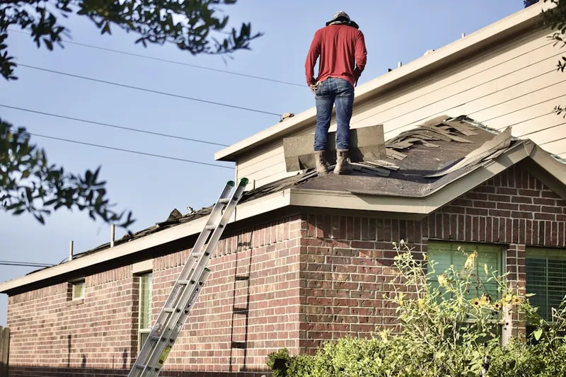 Professional roofer working on a residential roof in Downtown Detroit